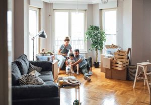 Family unpacking in a bright living room.